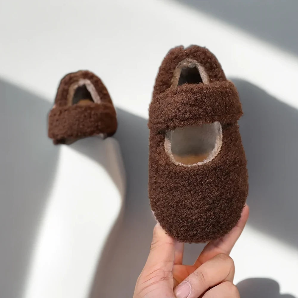 Enfant portant des mocassins hiver beiges assorties à sa tenue d'hiver décontractée
